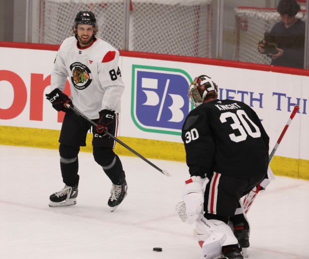 Left wing Landon Slaggert (84) and goaltender Spencer Knight (30) practice Thursday, Sept. 18, 2025, as the Chicago Blackhawks begin training camp at Fifth Third Arena. (Brian Cassella/Chicago Tribune)