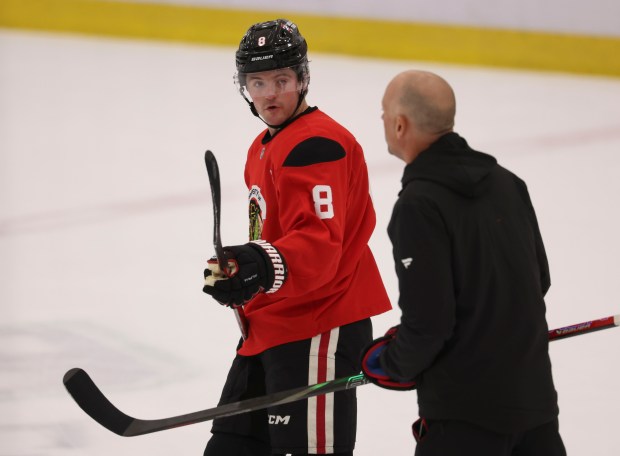 Center Ryan Donato (8) talks to coach Jeff Blashill during practice Thursday, Sept. 18, 2025, as the Chicago Blackhawks begin training camp at Fifth Third Arena. (Brian Cassella/Chicago Tribune)