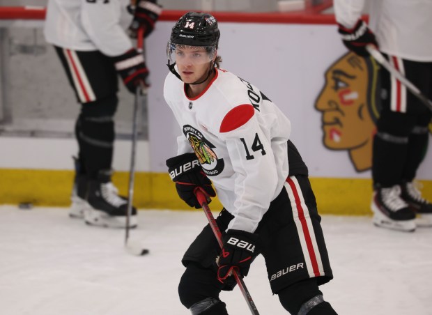 Defenseman Kevin Korchinski (14) practices Thursday, Sept. 18, 2025, as the Chicago Blackhawks begin training camp at Fifth Third Arena. (Brian Cassella/Chicago Tribune)