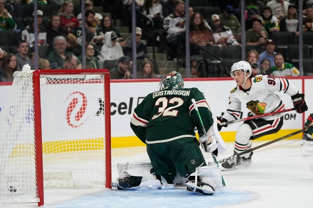 Chicago Blackhawks center Frank Nazar (91) scores a goal past Minnesota Wild goaltender Filip Gustavsson (32) during the second period of an NHL hockey preseason game, Sunday, Sept. 28, 2025, in St. Paul, Minn. (AP Photo/Abbie Parr)