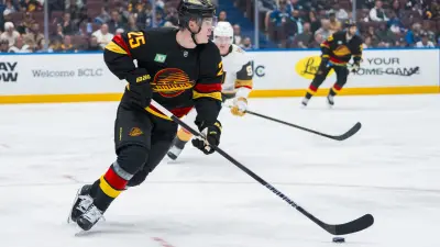 Apr 6, 2025; Vancouver, British Columbia, CAN; Vancouver Canucks defenseman Elias Pettersson (25) handles the puck against the Vegas Golden Knights in the third period at Rogers Arena.