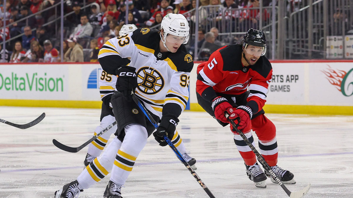 Boston Bruins center Fraser Minten (93) skates with the puck as New Jersey Devils defenseman Brenden Dillon (5) defends during the third period at Prudential Center. 