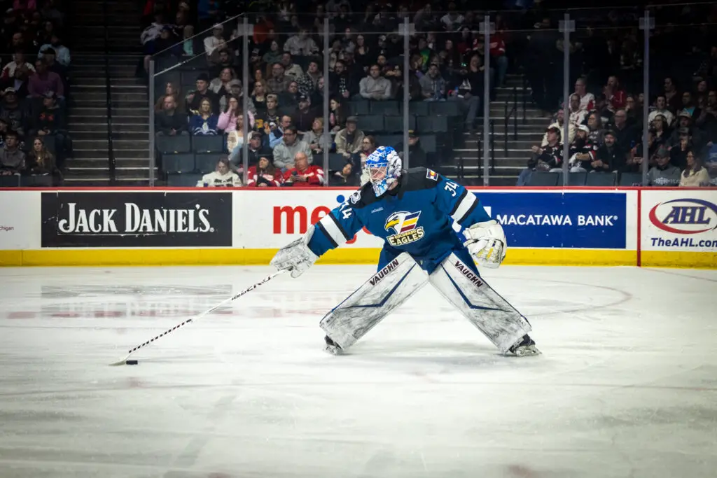 Adam Schell plays a puck 