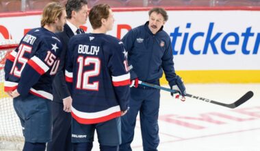 Guy Gaudreau, right, the father of the late Johnny and Matthew Gaudreau joins U.S.A. team players Noah Hanifin (15) and Matt Boldy (12) on the ice during 4 Nations Face-Off hockey practice in Montreal, Tuesday, Feb. 11, 2025.