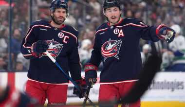 Boone Jenner #38 of the Columbus Blue Jackets talks with Zach Werenski #8 of the Columbus Blue Jackets during a stoppage in play against the Vancouver Canucks at Nationwide Arena on March 28, 2025 in Columbus, Ohio.