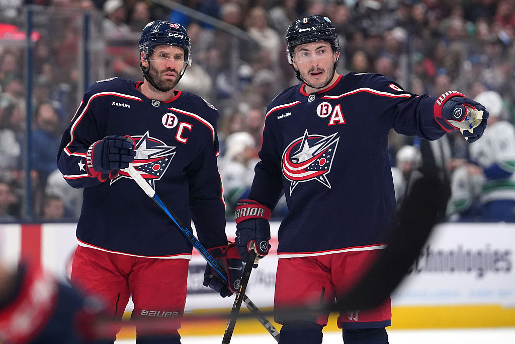 Boone Jenner #38 of the Columbus Blue Jackets talks with Zach Werenski #8 of the Columbus Blue Jackets during a stoppage in play against the Vancouver Canucks at Nationwide Arena on March 28, 2025 in Columbus, Ohio.