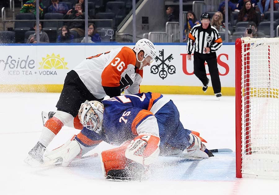 ELMONT, NEW YORK - SEPTEMBER 21: Emil Andrae #36 of the Philadelphia Flyers scores the game winning goal in the shootout against Parker Gahagen #75 of the New York Islanders in a preseason game at UBS Arena on September 21, 2025 in Elmont, New York. The Flyers defeated the Islanders 3-2 in the shootout.