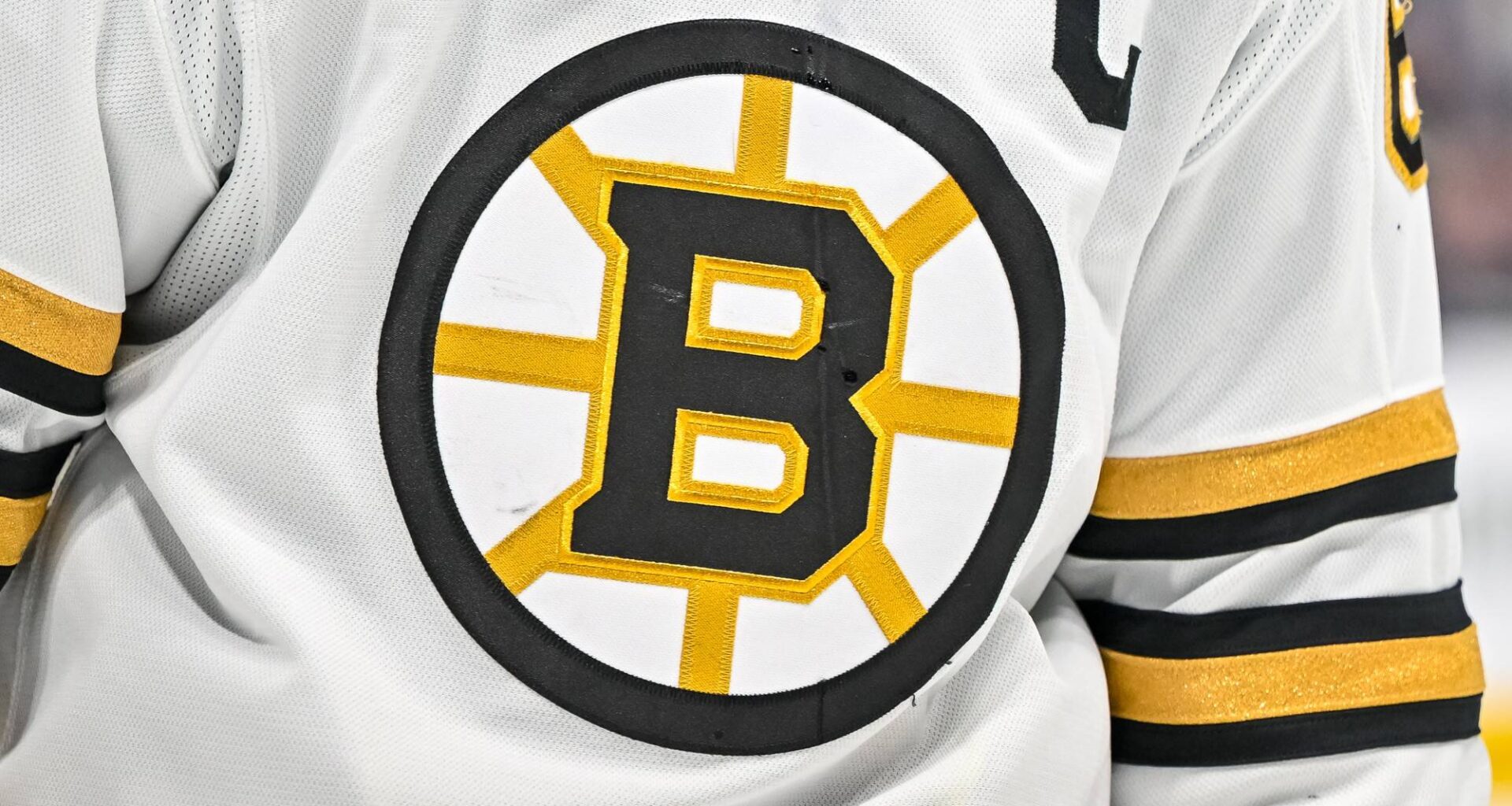 Boston Bruins logo against the San Jose Sharks