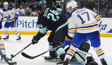 Seattle Kraken defenseman Jamie Oleksiak (24) blocks a shot against the Buffalo Sabres as left wing Jason Zucker (17) looks on during the third period of an NHL hockey game Monday, Jan. 20, 2025, in Seattle. (AP Photo/Lindsey Wasson)