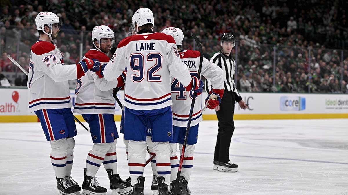Montreal Canadiens center Alex Newhook (15) and left wing Patrik Laine (92) and defenseman Lane Hutson (48) and center Kirby Dach (77) celebrates a goal scored Newhook against the Dallas Stars during the third period at the American Airlines Center.