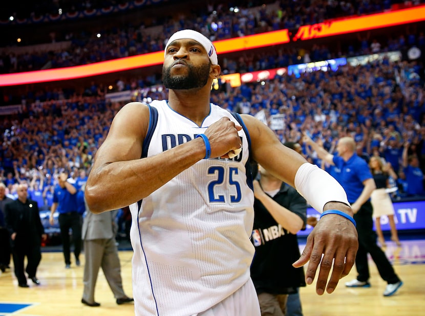 Dallas Mavericks guard Vince Carter (25) beats his chest was he walks off the court...