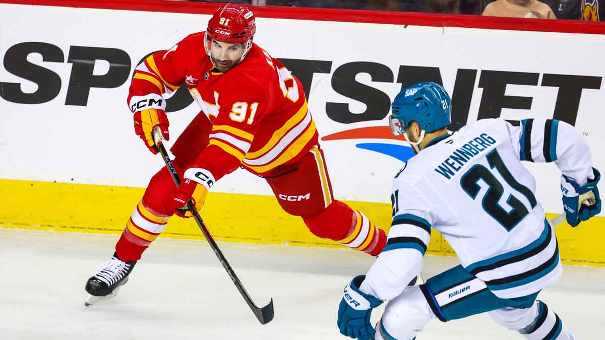 Calgary Flames center Nazem Kadri (91) controls the puck against San Jose Sharks center Alexander Wennberg (21) during the first period at Scotiabank Saddledome.