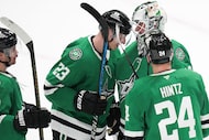 Dallas Stars goaltender Jake Oettinger (29) celebrates with defenseman Esa Lindell (23) and...