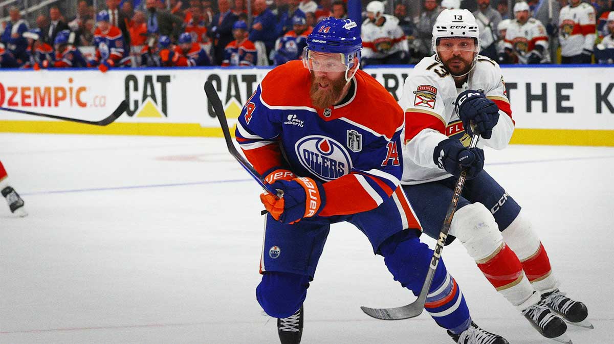 Edmonton Oilers defenseman Mattias Ekholm (14) battles for the puck against Florida Panthers forward Sam Reinhart (13) during the second period in game five of the 2025 Stanley Cup Final at Rogers Place.