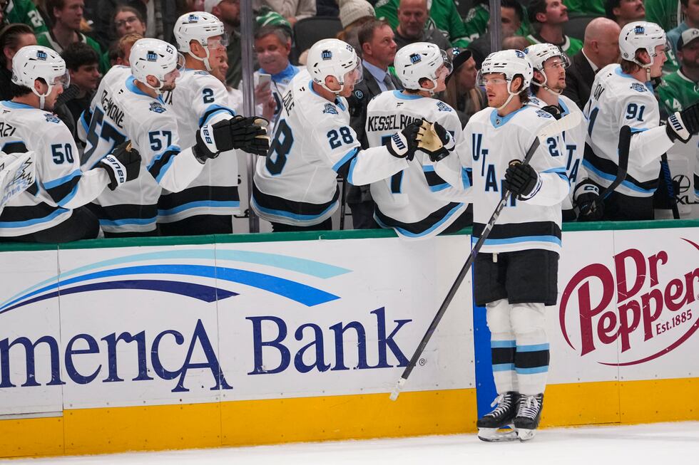 Utah Hockey Club center Barrett Hayton skates by his bench after scoring a goal on the Dallas...