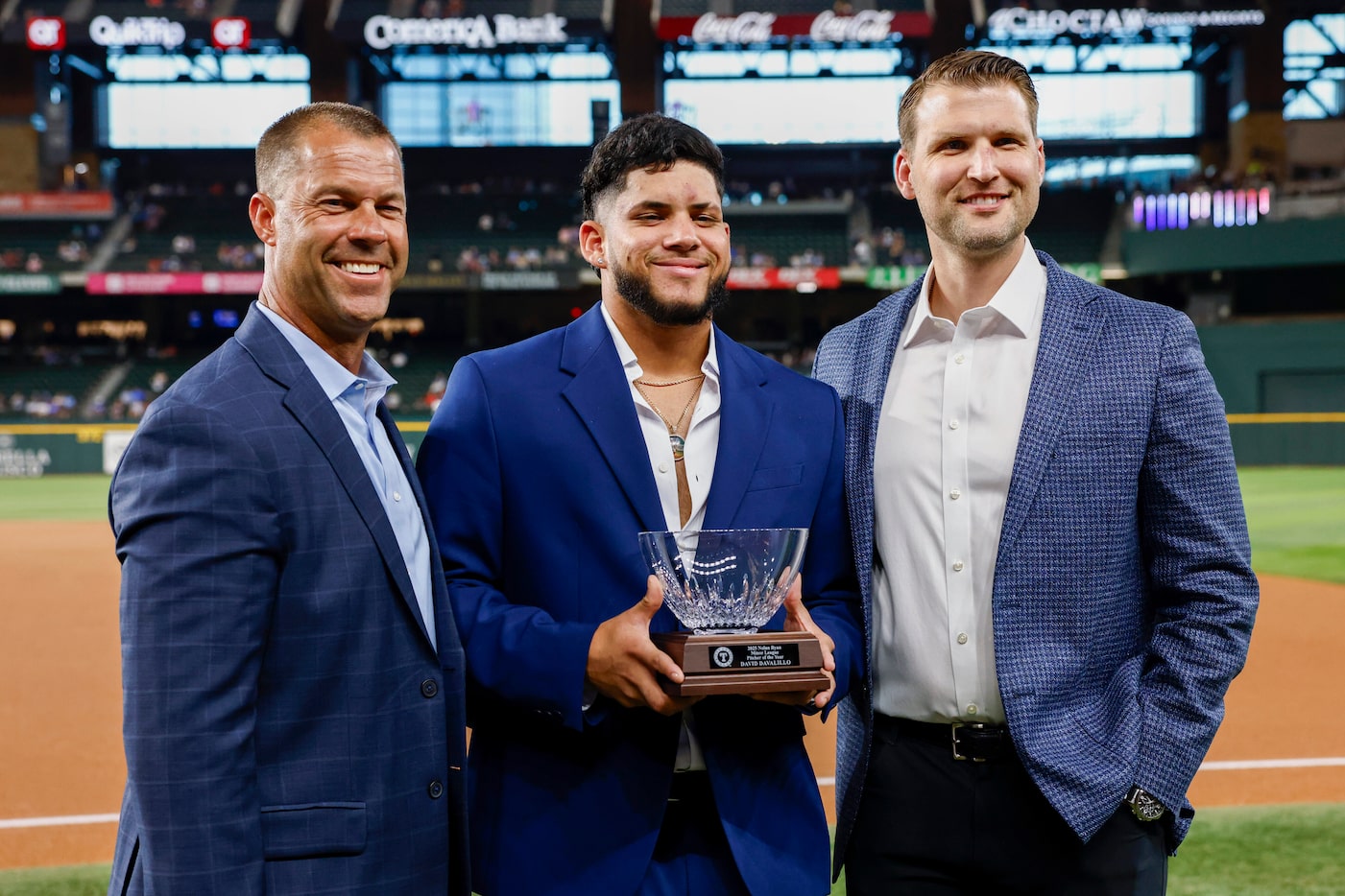 Texas Rangers minor league pitcher David Davalillo (center) is presented with the 2025 Nolan...