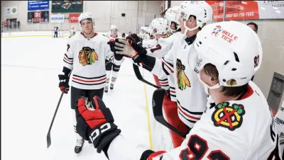Blackhawks go through the Fist Bump line after tying game vs St. Louis in Tom Kurvers Showcase. Photo Credit NHL Chicago Blackhawks