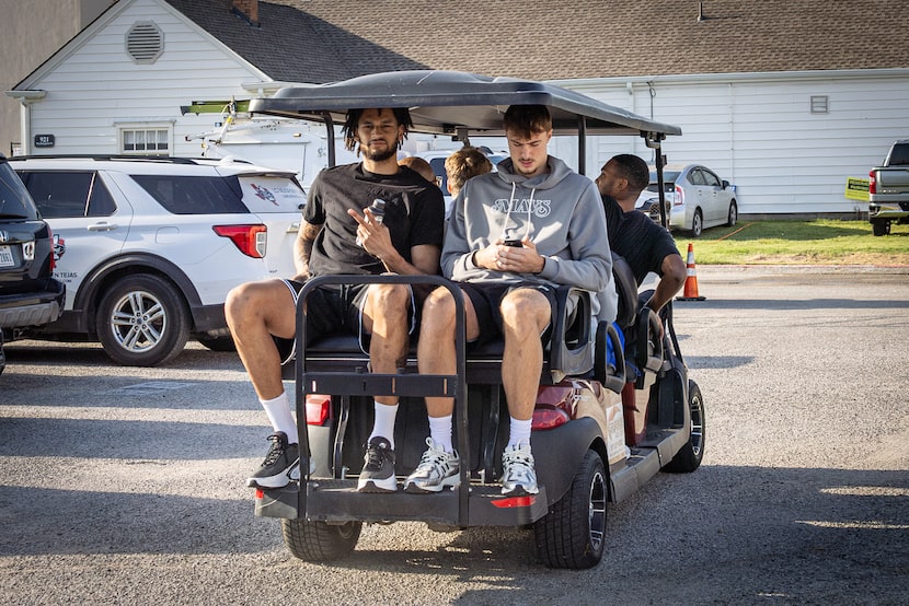 Dallas Mavericks Dereck Lively II and overall 1st round draft pick Cooper Flagg catch a golf...