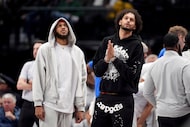 Dallas Mavericks' Daniel Gafford, left, and Dereck Lively II, right, stand on the court...
