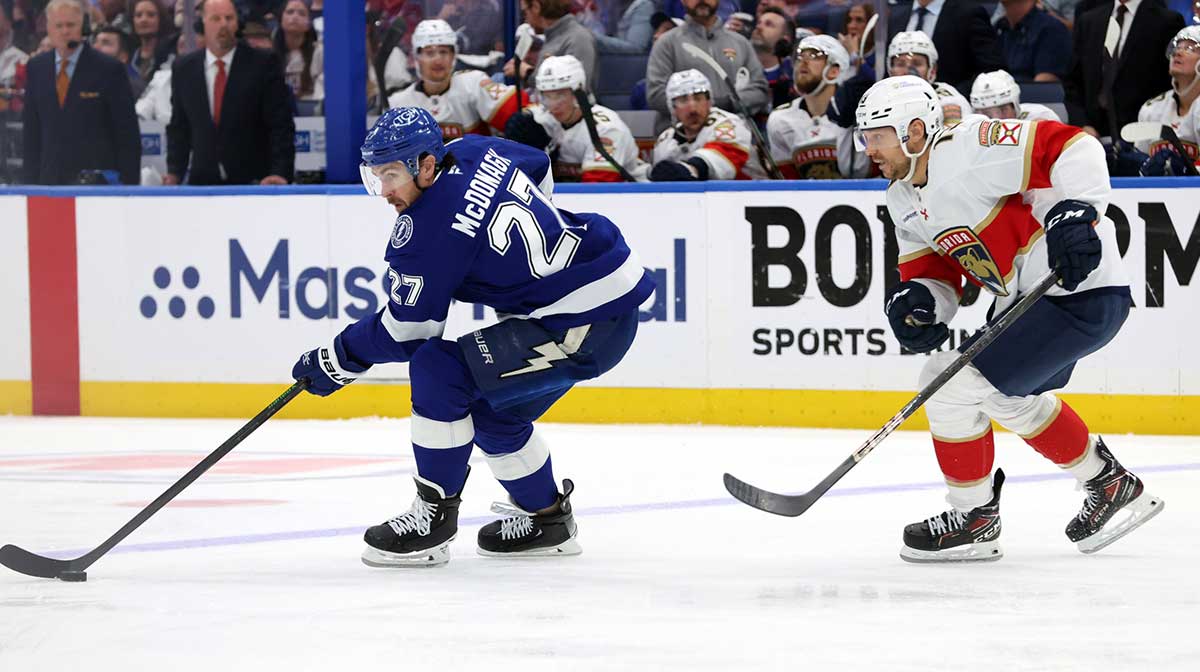 Tampa Bay Lightning defenseman Ryan McDonagh (27)] skates with the puck as Florida Panthers center Sam Reinhart (13) defends during the third period of game five of the first round of the 2025 Stanley Cup Playoffs at Amalie Arena.