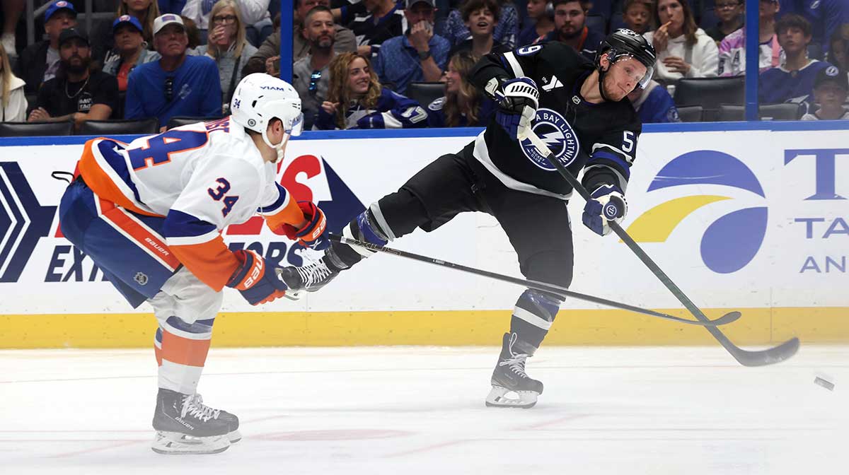 Tampa Bay Lightning center Jake Guentzel (59) passed the puck as New York Islanders defenseman Adam Boqvist (34) defends during the second period at Amalie Arena.