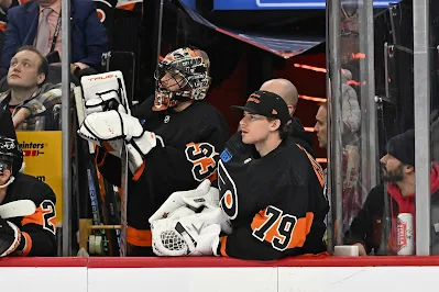 Carter Hart, Philadelphia Flyers goalie, looks on from bench