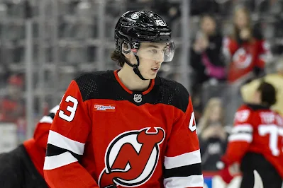Luke Hughes, NJ Devils defenseman, warms up before a game