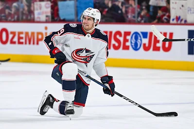 Yegor Chinakhov, Columbus Blue Jackets forward, kneels during warmup