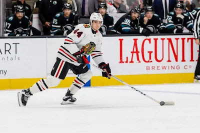 Chicago Blackhawks defenseman Wyatt Kaiser skates with the puck during 2025 game.