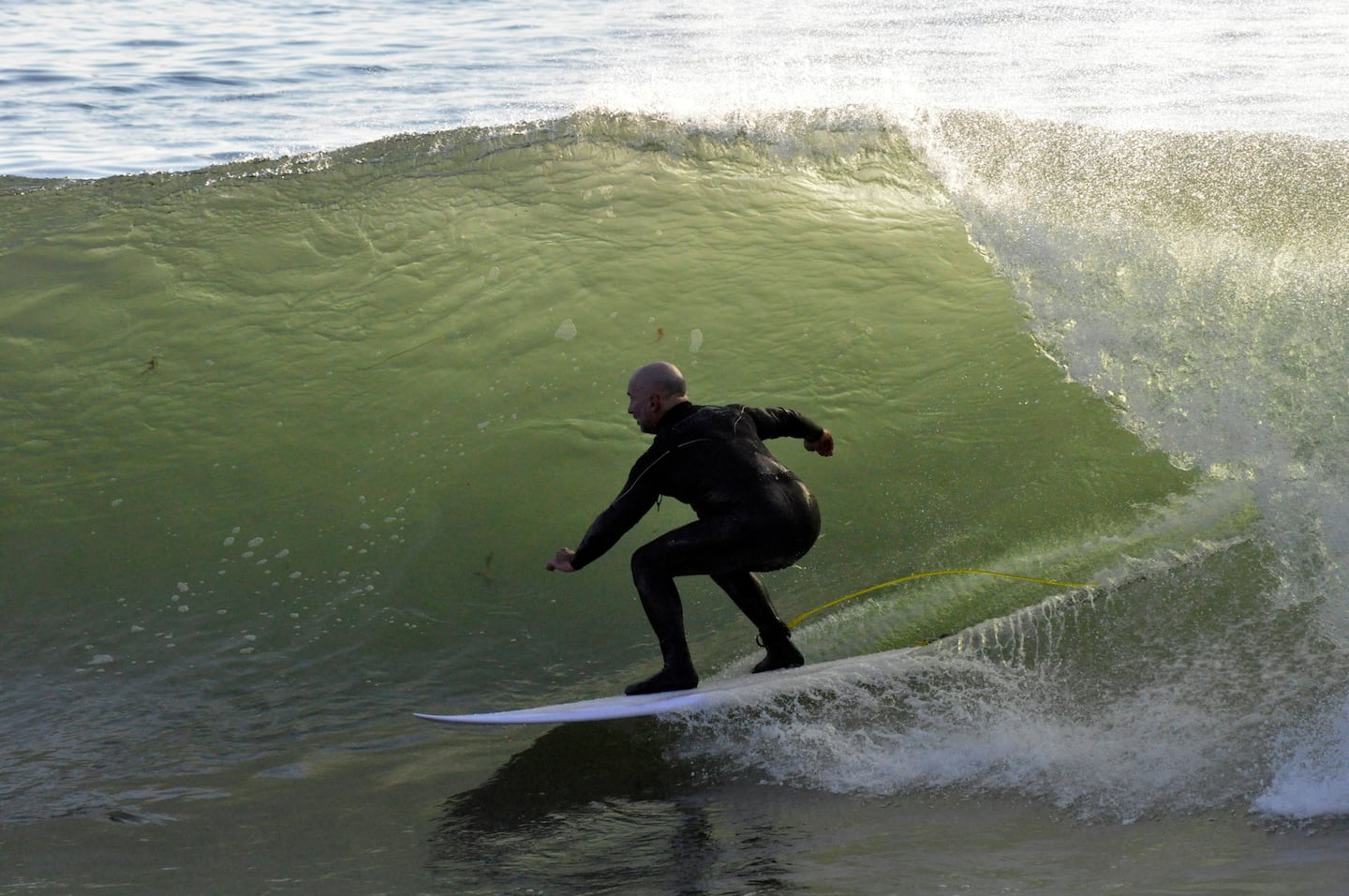 Former Bruins player Ken Linseman surfs off the New Hampshire coast in 2014.