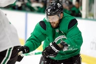 Dallas Stars center Tyler Seguin (91) gets his stick around a teammate as they played in a...
