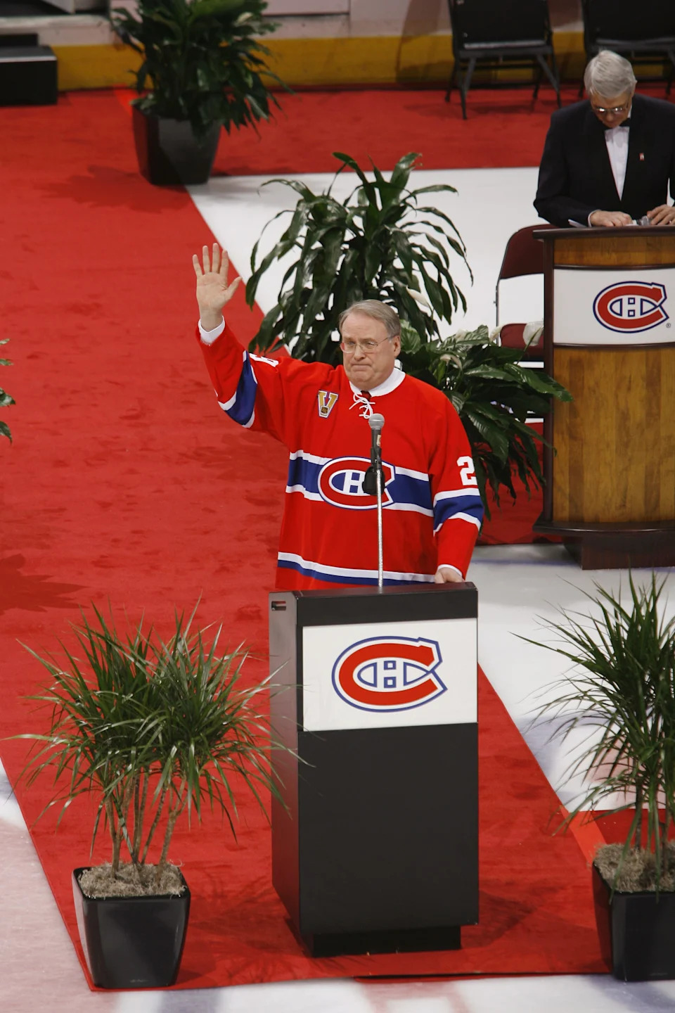 Former Montreal Canadian Ken Dryden waves as he speaks during a ceremony in which his jersey is retired prior.
