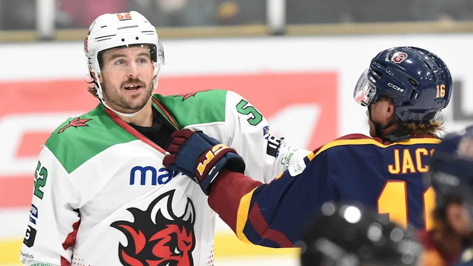 Cardiff Devils' Jimmy Oligny has his shirt neck grabbed by a Guildford Flames player