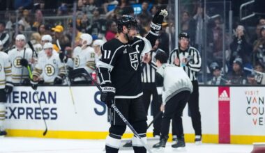 Los Angeles Kings center Anze Kopitar (11) reacts as he is recognized for breaking the team's record for number of games played during the first period of an NHL hockey game against the Boston Bruins Saturday, Oct. 21, 2023, in Los Angeles. (AP Photo/Ashley Landis)