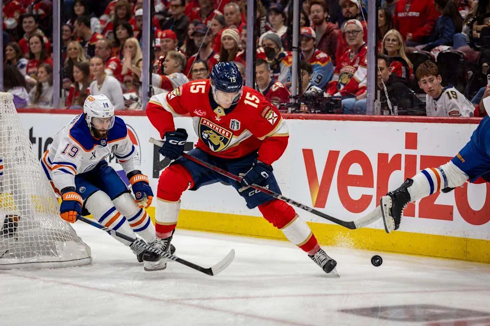 Florida Panthers center Anton Lundell (15) goes after the puck as Edmonton Oilers center Adam Henrique (19), left, attempts to take possession during the first period of Game 4 in the NHL Stanley Cup Final series at Amerant Bank Arena on Thursday, June 12, 2025, in Sunrise, Fla.
