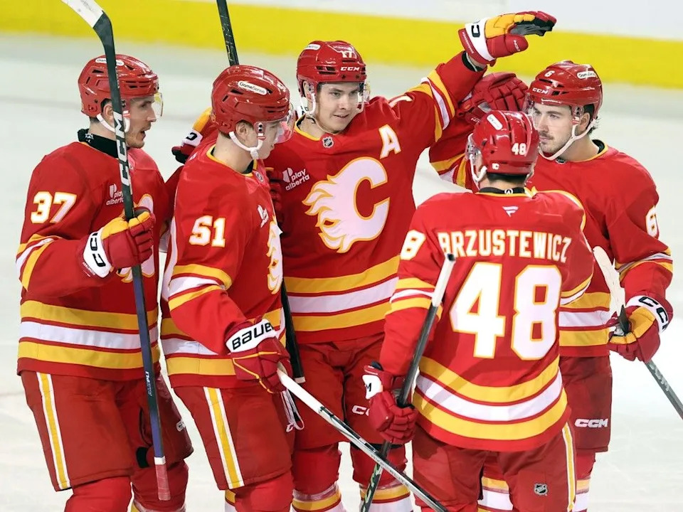 The Flames celebrate a goal by Yegor Sharangovich against the Kraken on Tuesday.