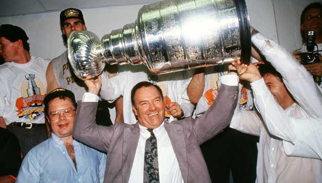 BLOOMINGTON, MN - MAY 25:  Director of Player Personnel Scotty Bowman hoists the Stanley Cup Trophy in the locker room after the Penguins defeated the Minnesota North Stars in Game 6 of the Stanley Cup Finals on May 25, 1991 at the Met Center in Bloomington, Minnesota.  The Penguins won the series 4-2.  (Photo by Bruce Bennett Studios via Getty Images Studios/Getty Images)