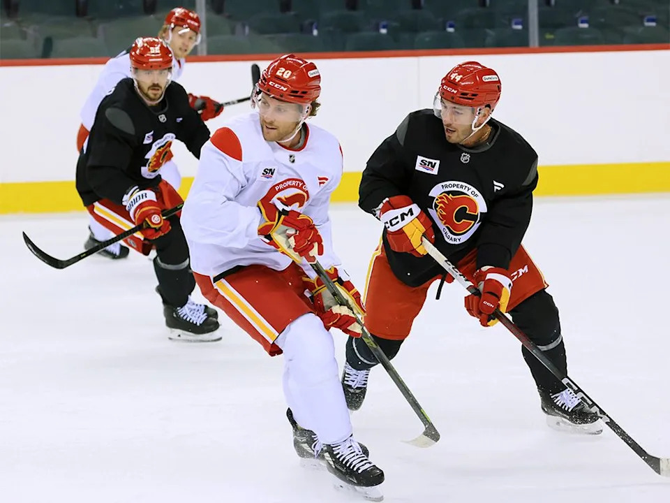  Calgary Flames from left; defenceman MacKenzie Weegar, forward Blake Coleman and defenceman Joel Hanley take part in the first day of training camp at the Scotiabank Saddledome on Thursday, Sept. 18, 2025.