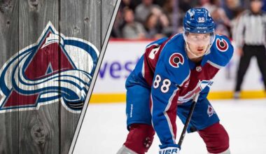 Colorado Avalanche forward Martin Necas skates with the puck during an NHL game, with the crowd blurred in the background.