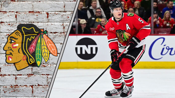 Chicago Blackhawks defenseman Connor Murphy skates during an NHL game, with the Blackhawks logo visible in the background, sparking NHL trade rumors discussions.