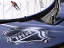 An NHL logo is shown as Washington Capitals defenceman Brenden Dillon (4) skates prior to NHL Eastern Conference Stanley Cup playoff hockey action against the New York Islanders in Toronto on Friday, Aug. 14, 2020.