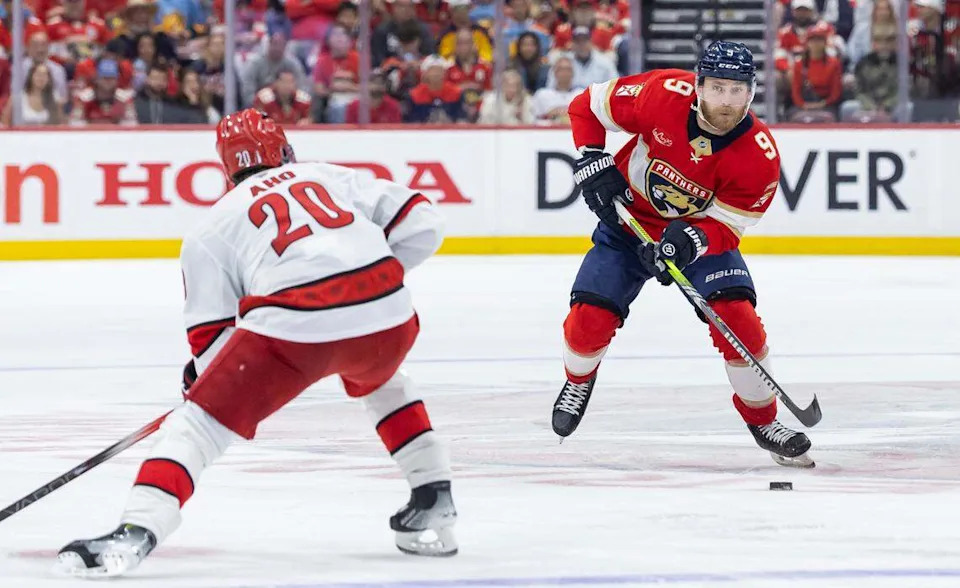 Florida Panthers center Sam Bennett (9) looks to pass the puck as Carolina Hurricanes center Sebastian Aho (20) defends in the second period of Game 4 during the Eastern Conference final of the NHL Stanley Cup playoffs at Amerant Bank Arena on Monday, May 26, 2025, in Sunrise, Fla.