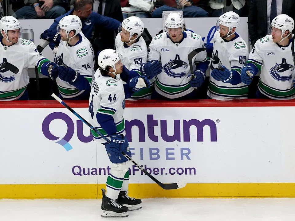  Canucks winger Kiefer Sherwood celebrates after scoring against the Colorado Avalanche on April 10 in Denver.