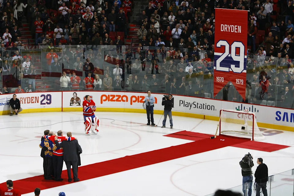 Ken Dryden, former goaltender of the Montreal Canadiens, and his family watch as his jersey #29 is retired.