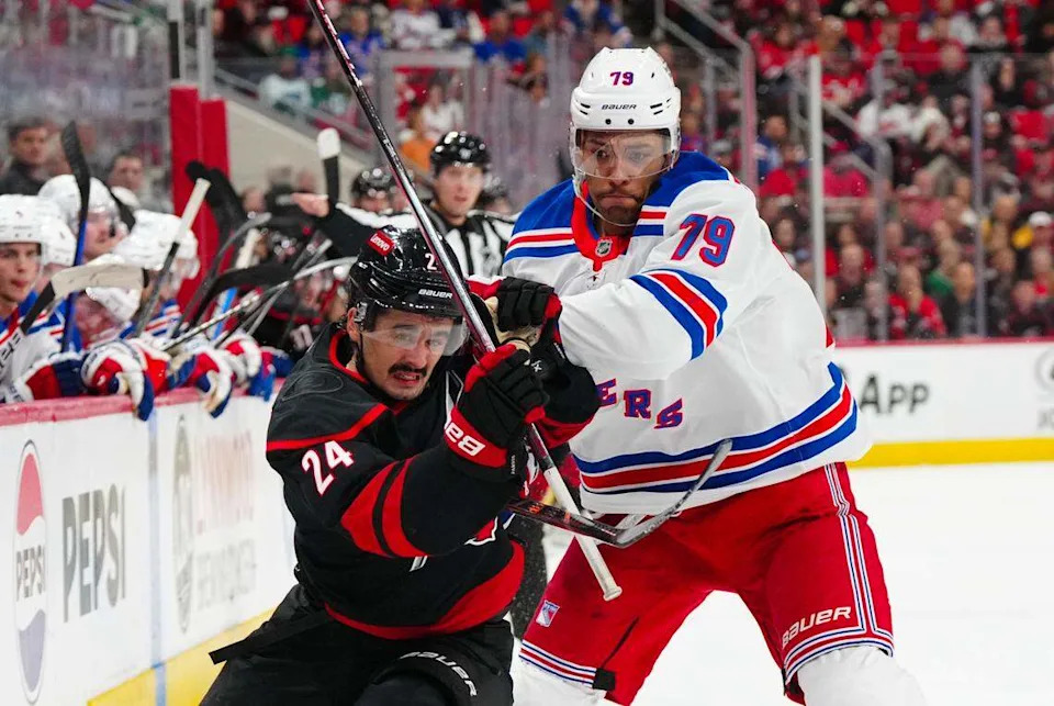 New York Rangers defenseman K’Andre Miller (79) jostles with Carolina Hurricanes center Seth Jarvis (24). The Hurricanes traded for Miller on Tuesday and signed him to an eight-year deal.