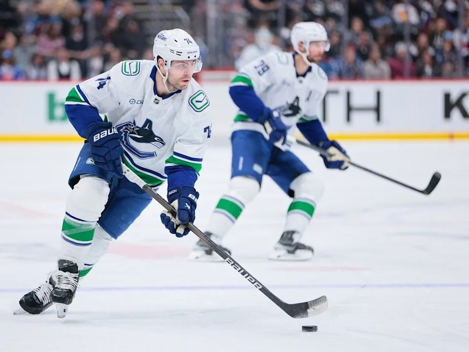 Jake DeBrusk skates with the puck against the Colorado Avalanche, April 10.