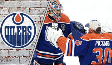 Edmonton Oilers goalies celebrating a win, with the team's logo in the background.