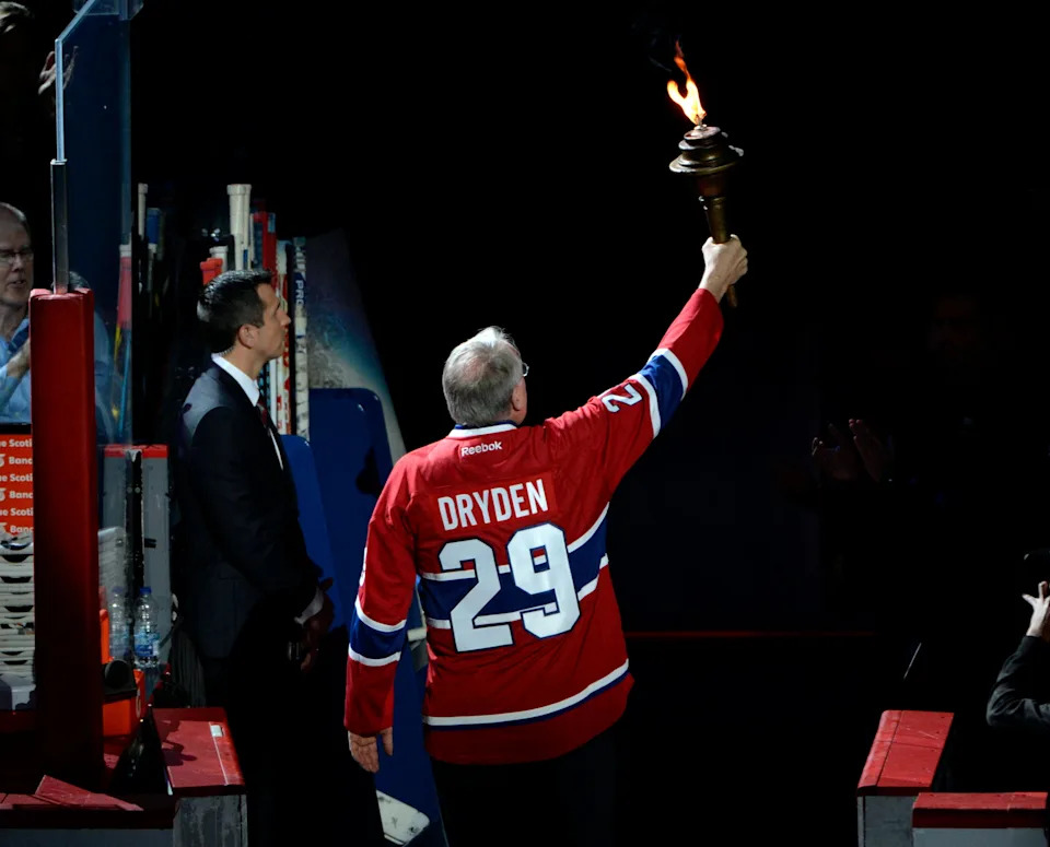 Former Canadiens former goalie Ken Dryden brings the torch before the game between the Boston Bruins and the Montreal Canadiens.