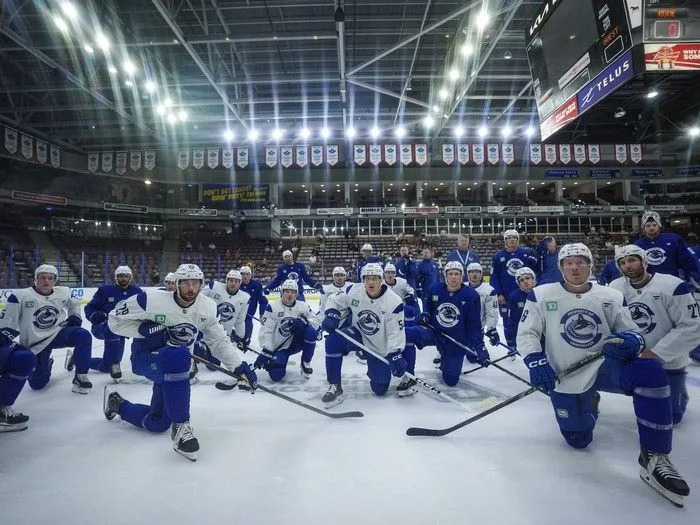  Vancouver Canucks players, including Marcus Pettersson (29), Aatu Raty (54), Brock Boeser (6) and Derek Forbort (27) listen to instructions for a drill during the opening day of the NHL hockey team’s training camp, in Penticton, B.C., on Thursday, September 18, 2025.