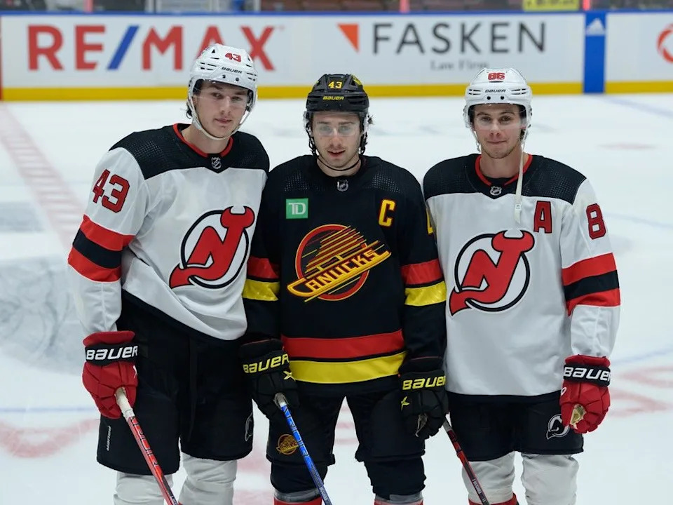  Canucks captain Quinn Hughes poses with brothers Luke (left) and Jack before a Dec. 5, 2023 game at Rogers Arena.
